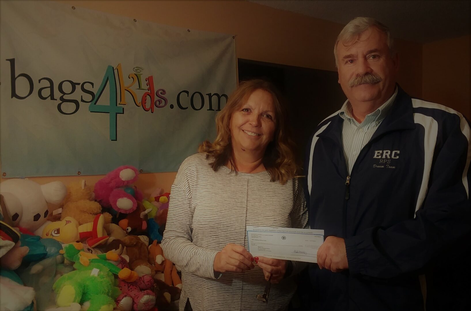LaJuana Moser donating a check to Bags4Kids